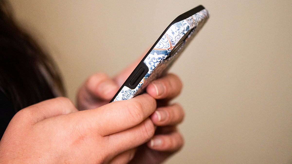 Woman holding her phone.