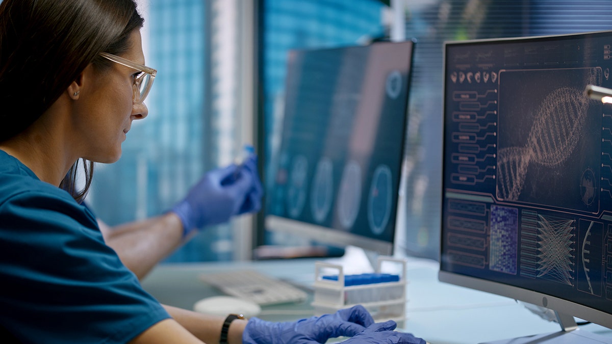 Medical staff examining the samples under a microscope to detect and prevent