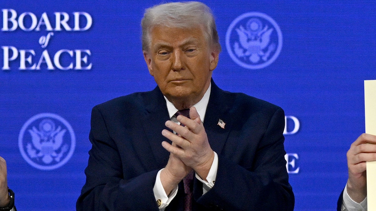 President Donald Trump claps in Davos