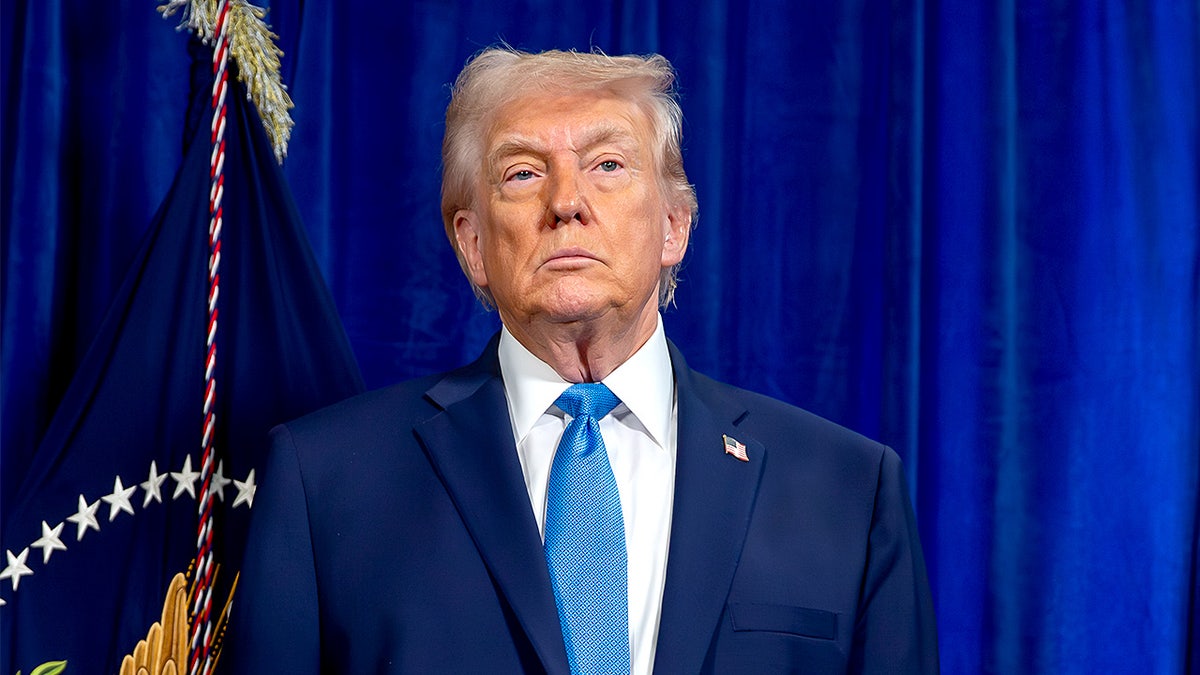 President Donald Trump speaks at a podium during a news conference at Mar-a-Lago.
