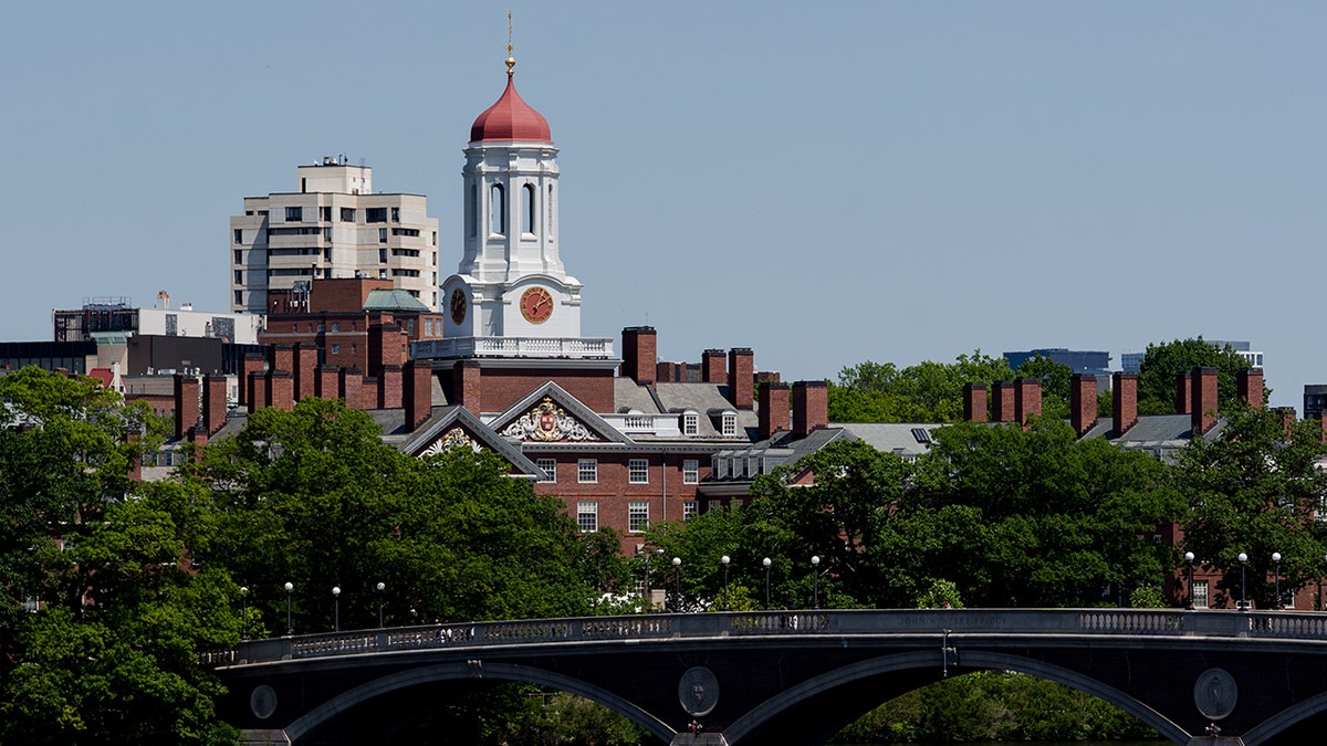 Brick Dunster House residence hall at Harvard with Charles river in foreground