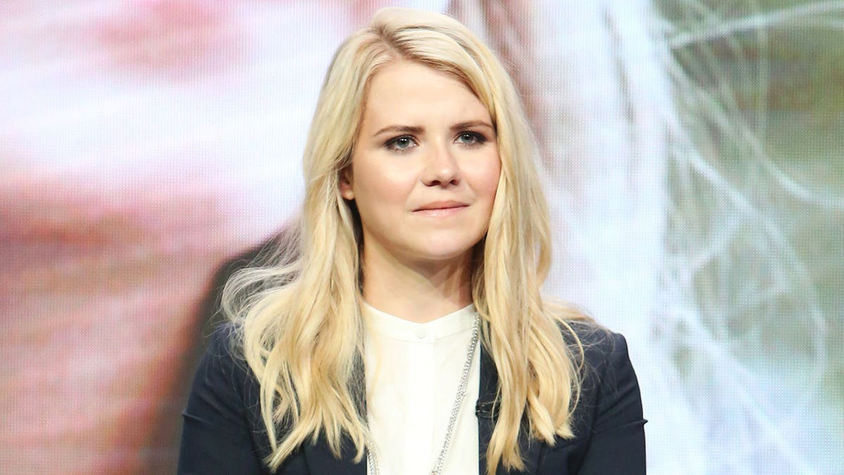 A close-up of kidnapping survivor Elizabeth Smart wearing a dark blazer and a white shirt.