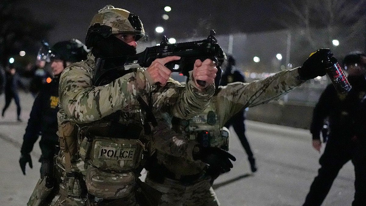 Federal immigration officer confronts a demonstrator outside federal building in Minneapolis