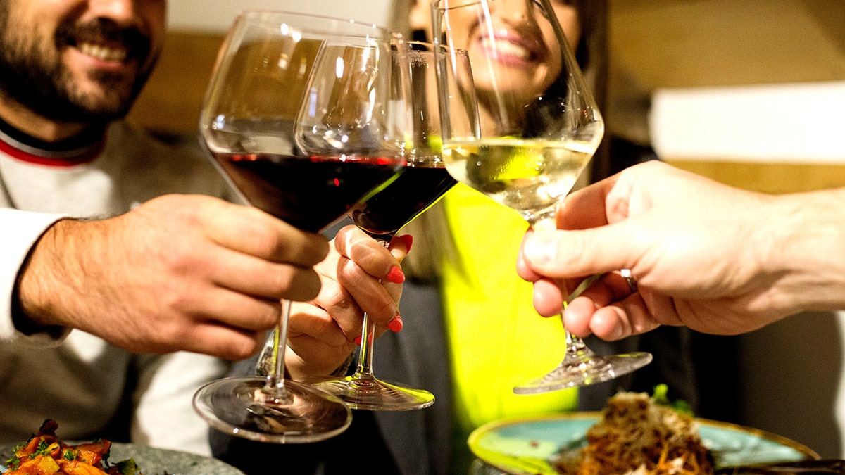 People celebrating with red and white wine