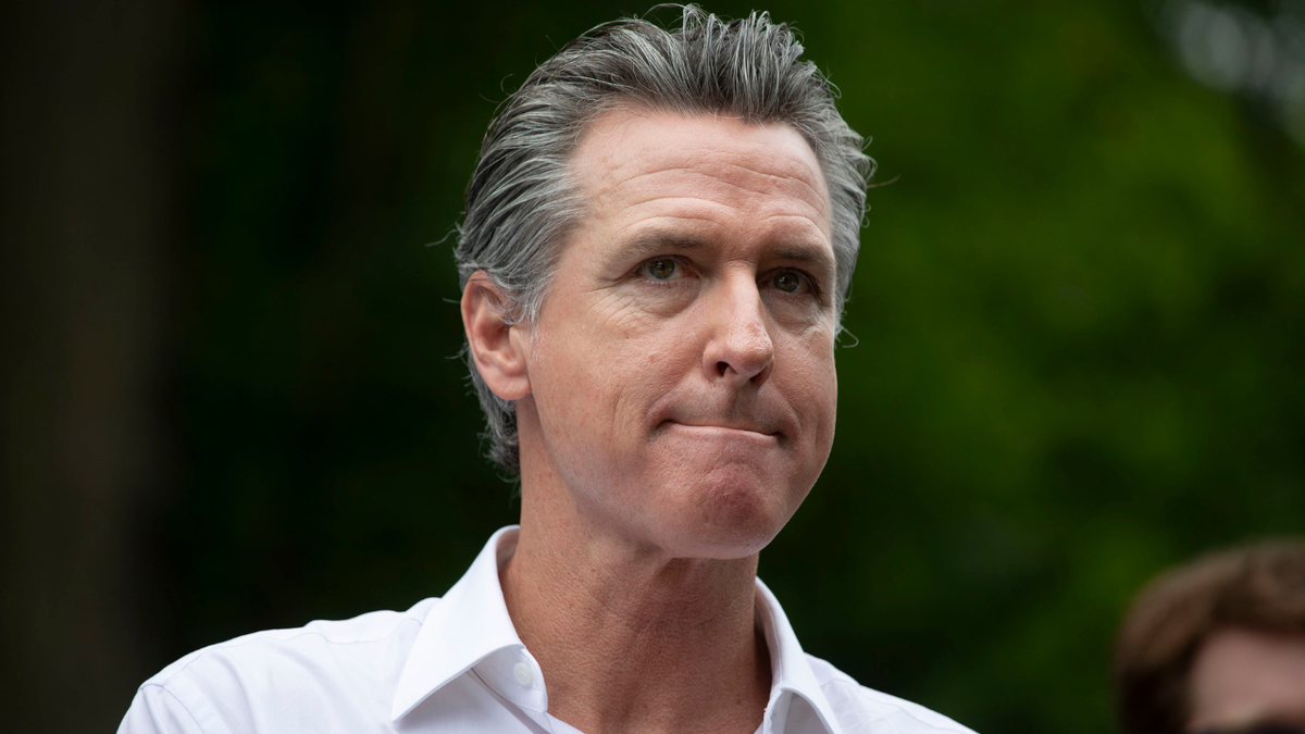 California Gov. Gavin Newsom listens to a question at an event.