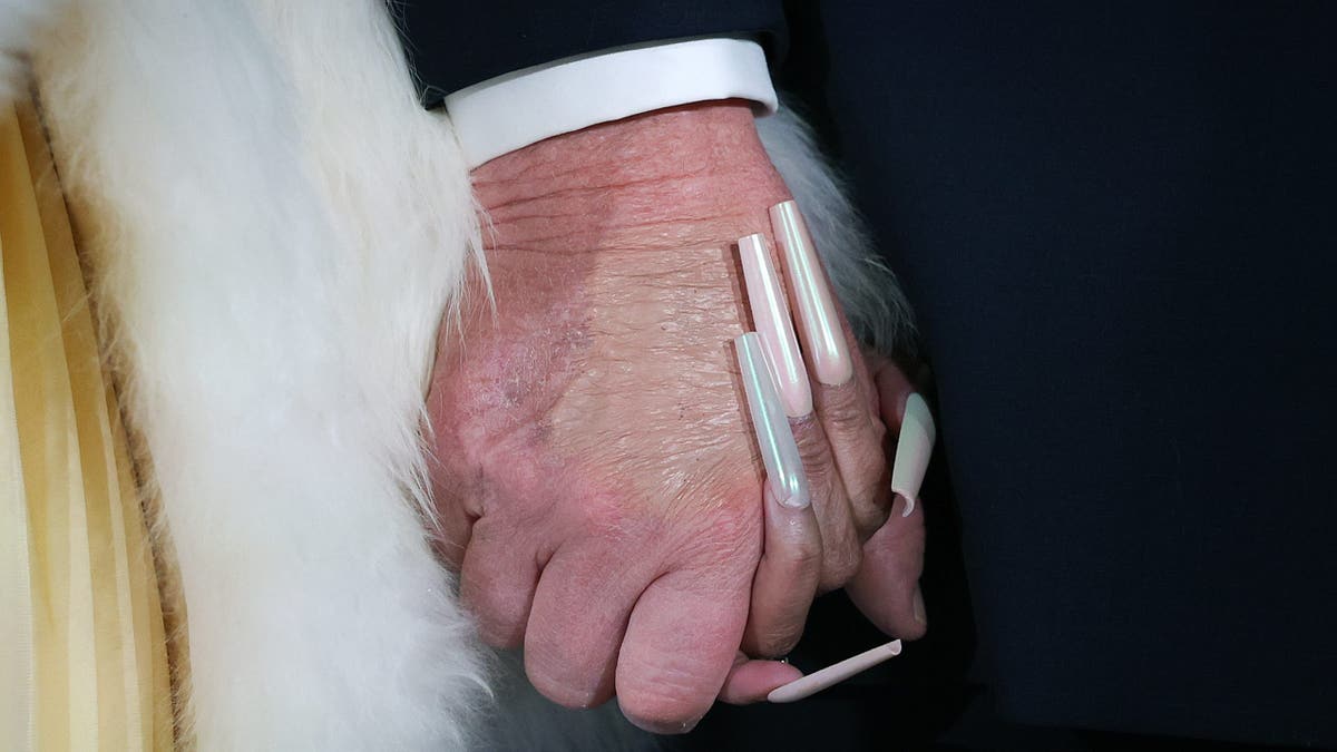 Close up of Nicki Minaj and Donald Trump holding hands