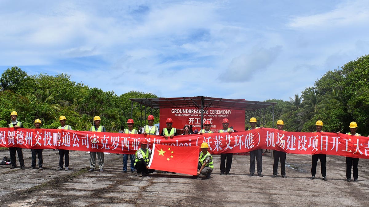 The groundbreaking ceremony for the Woleai runway project in Yap State. Representatives of a Chinese company hold a banner on stage. May, 2025.