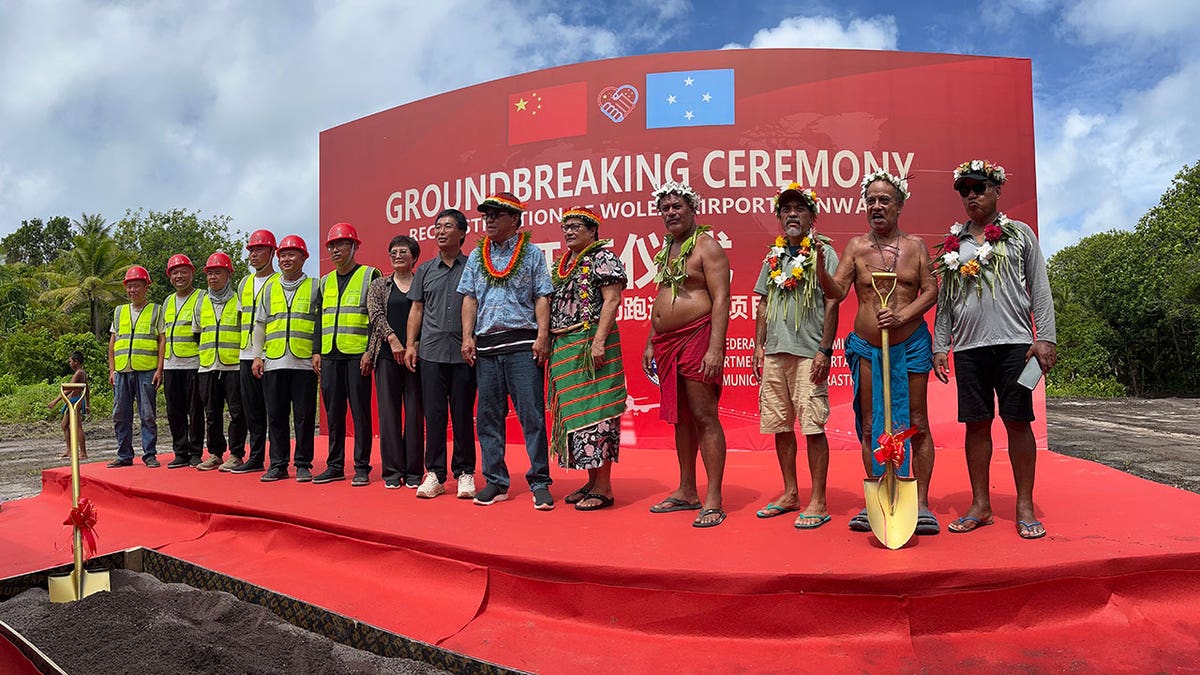 Officials attend the groundbreaking ceremony for the Woleai runway project in Yap State, with the president of the Federated States of Micronesia standing at center