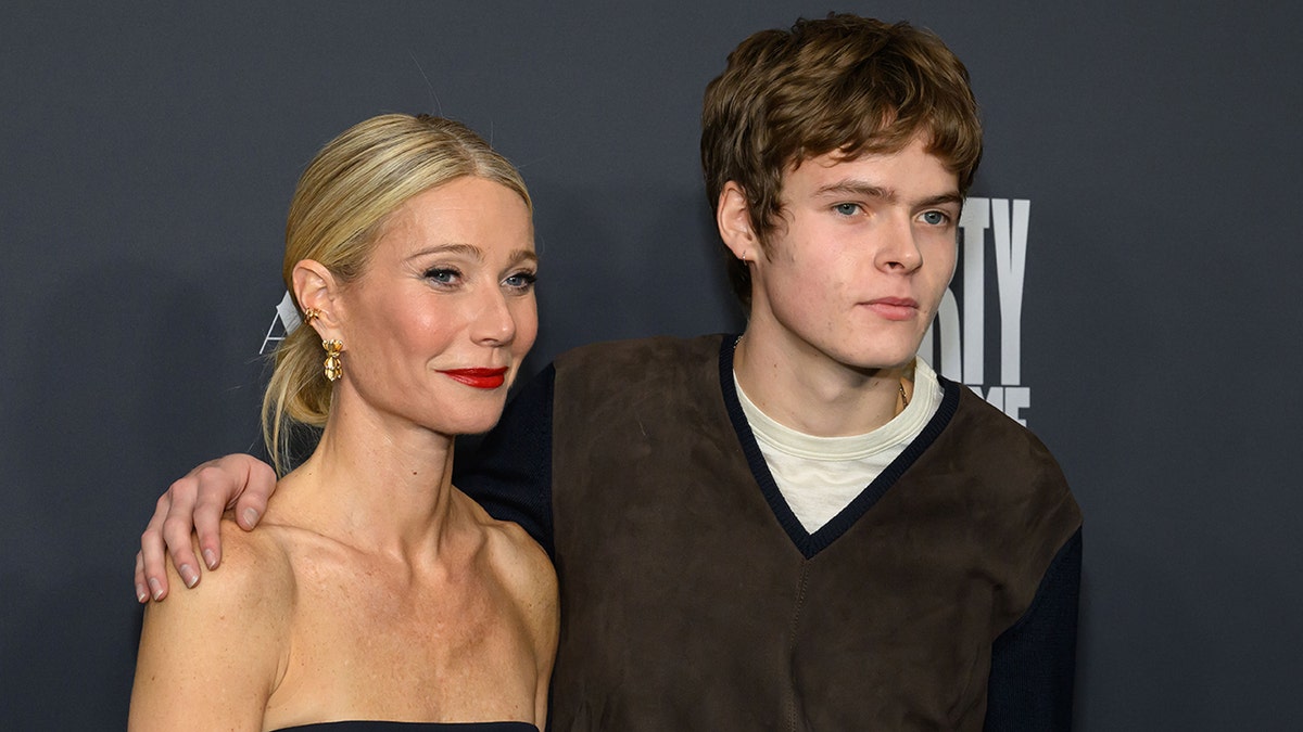 Gwyneth Paltrow poses with her son Moses Martin on the red carpet at the Marty Supreme premiere in Los Angeles.