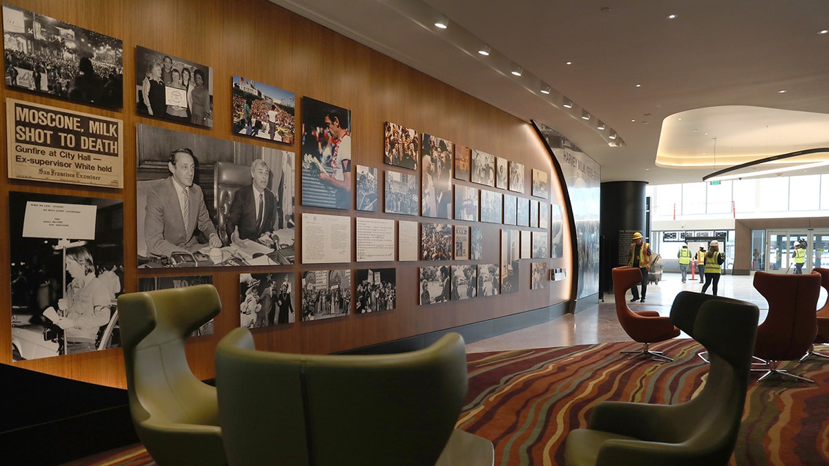 Harvey Milk Museum exhibit inside San Francisco International Airport featuring historical photographs, seating area, and modern interior design.