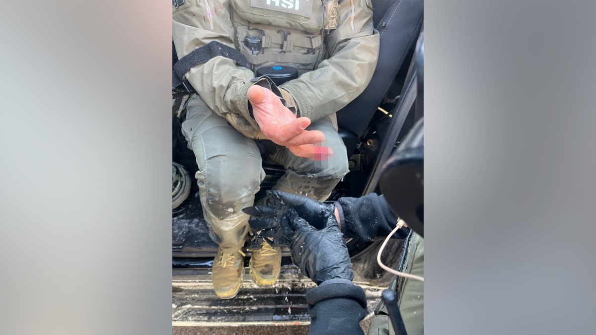 A blurred finger of an federal agent