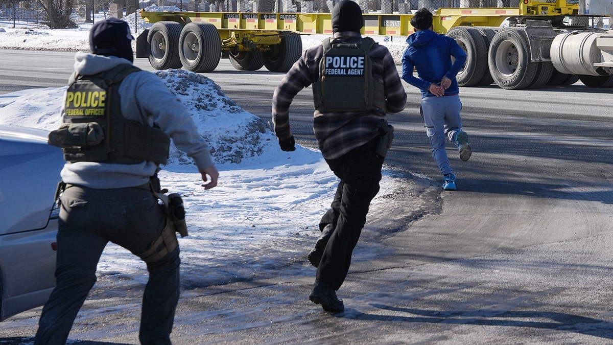 A man in handcuffs running away from federal immigration agents in Minneapolis.
