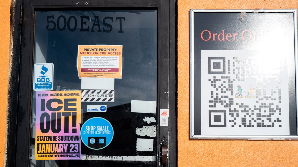 Posters show an upcoming "ICE OUT!" rally, as pictured in the window of a Minneapolis restaurant.