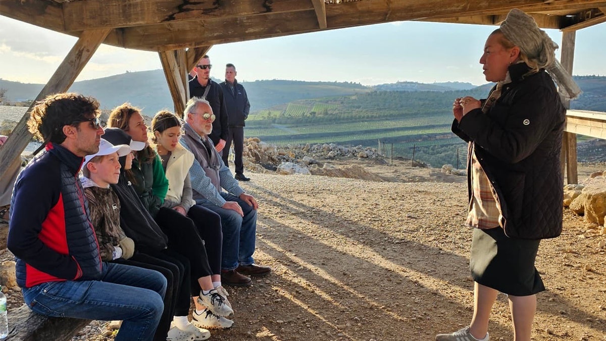 Sanders family listening to presentation in West Bank