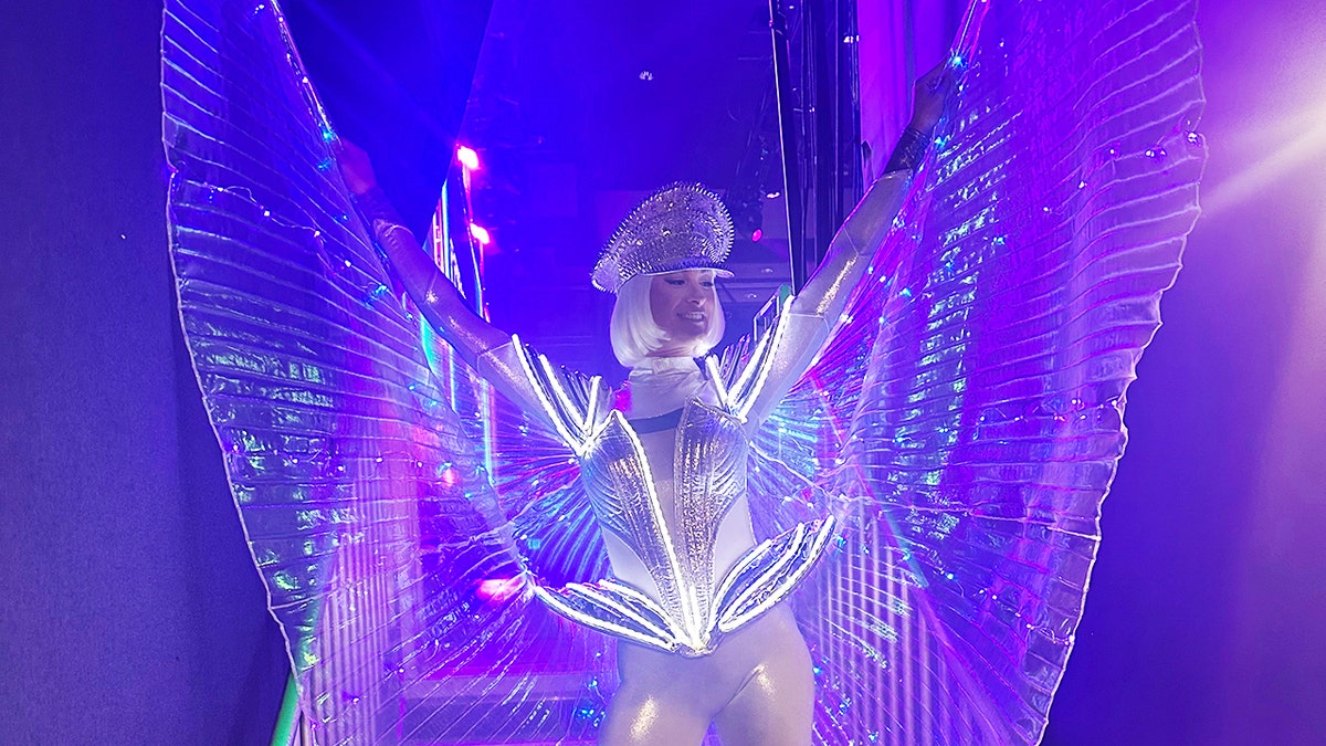 Kendra Bates in a light-up costume performing at night.