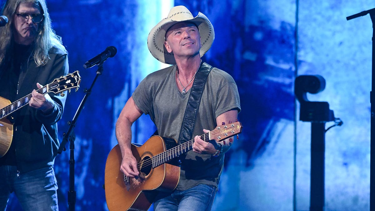 Kenny Chesney playing the guitar