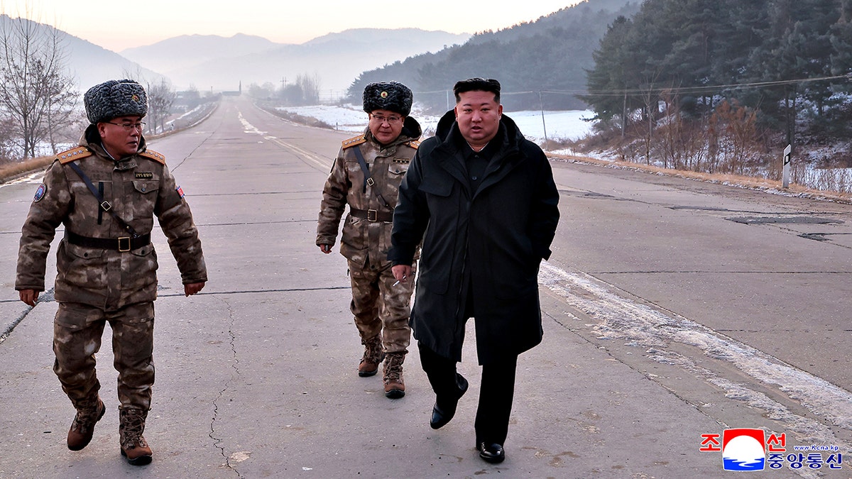 Kim Jong Un walking on road with military members