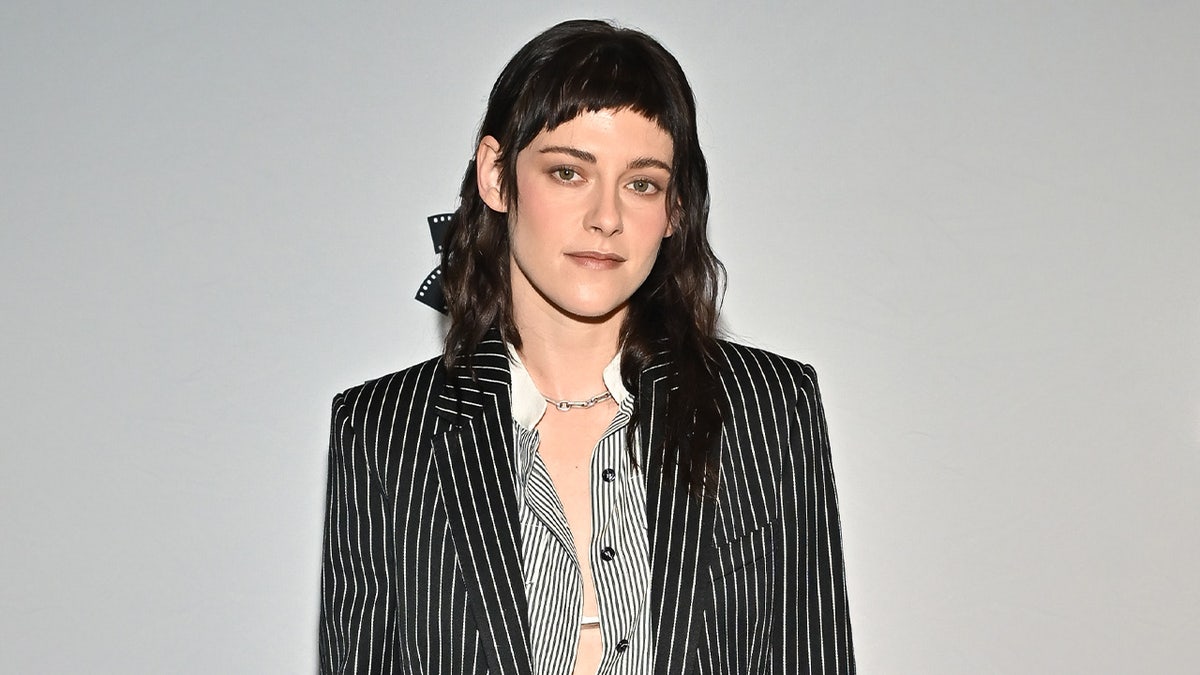 Kristen Stewart wears pinstripe suit.