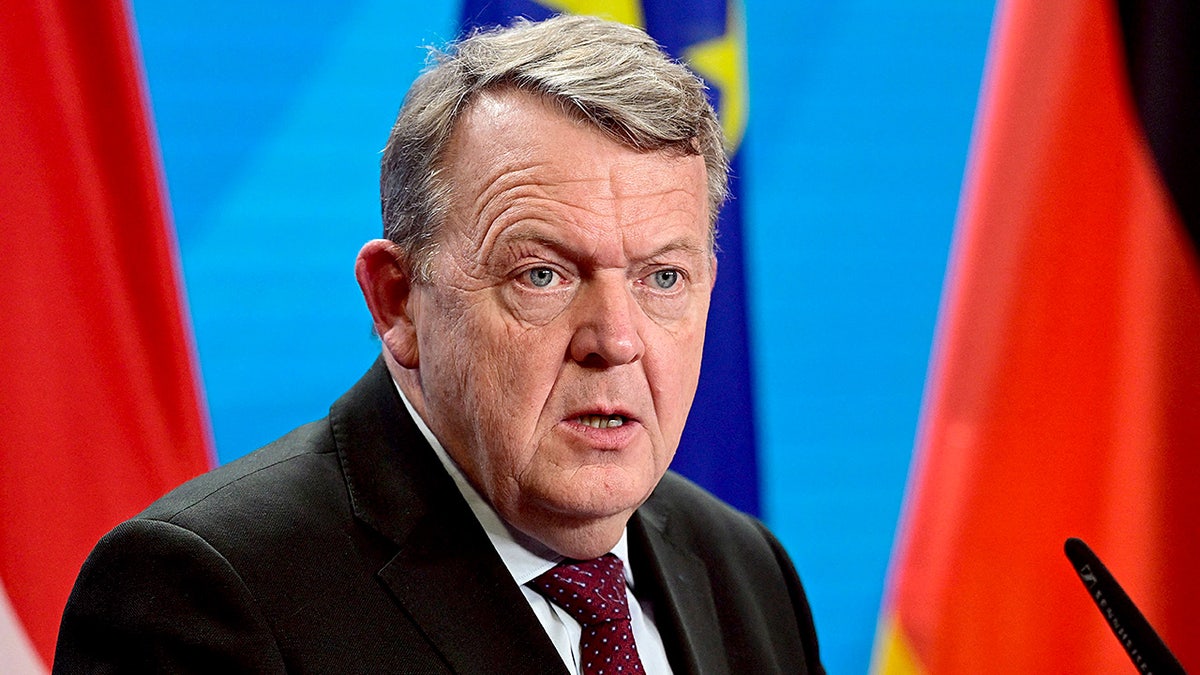 Danish Foreign Minister Lars Løkke Rasmussen speaks at a podium during a joint press conference.
