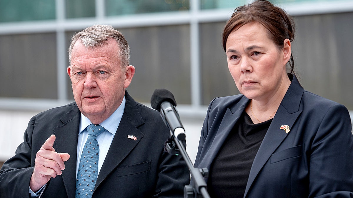 Danish Foreign Minister Lars Løkke Rasmussen and Greenlandic Foreign Minister Vivian Motzfeldt speak to reporters at a podium.