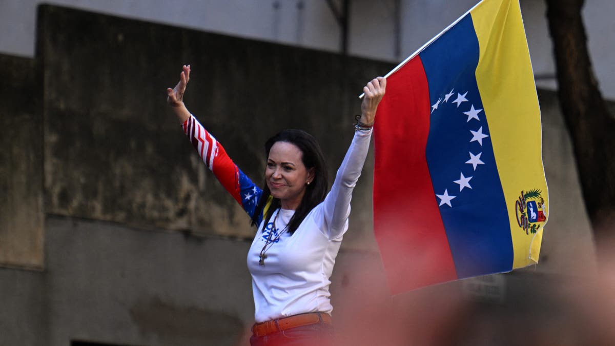 Venezuelan opposition leader Maria Corina Machado waves a national flag during a protest called by the opposition on the eve of the presidential inauguration, in Caracas on January 9, 2025.