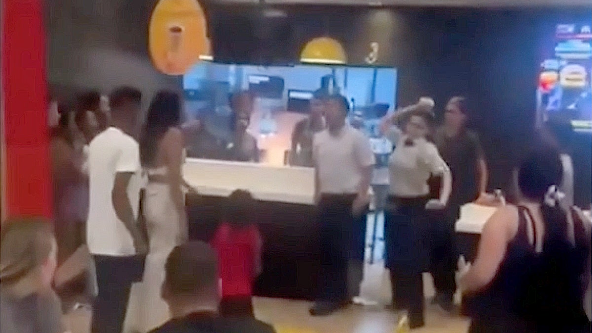 McDonald's worker hurls an item at a customer