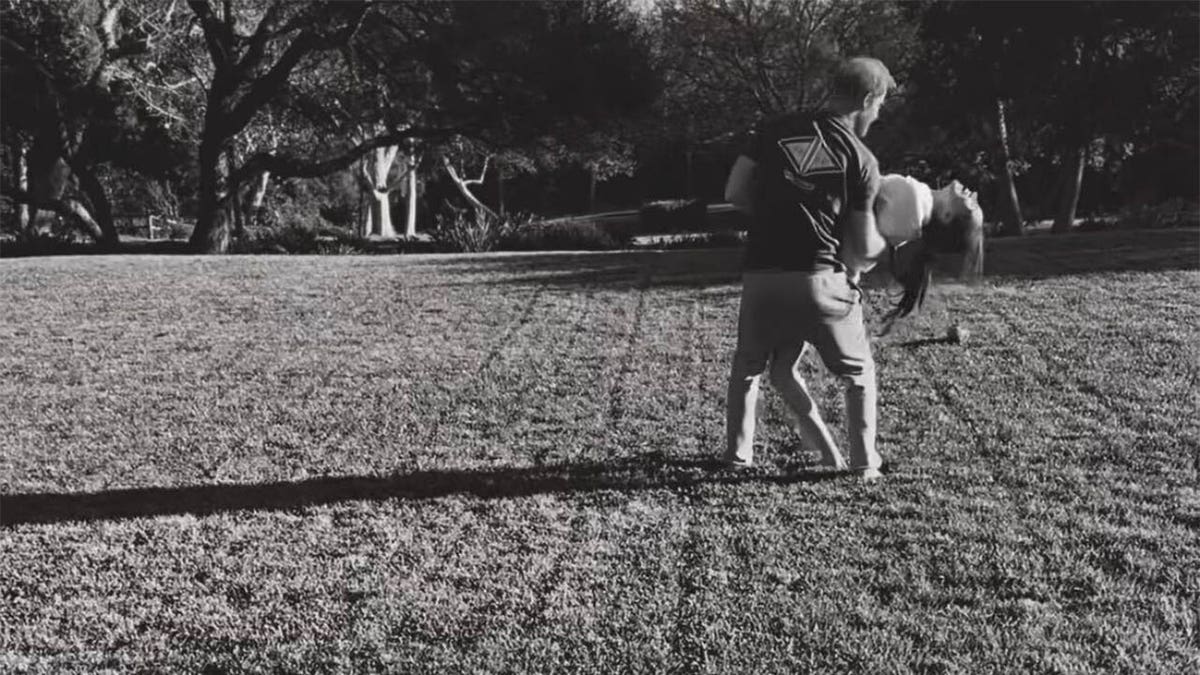 Prince Harry lowers Meghan Markle into dip 