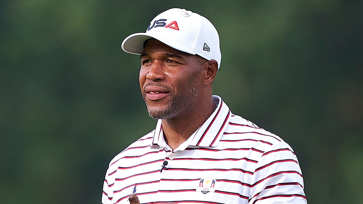 Michael Strahan looks on