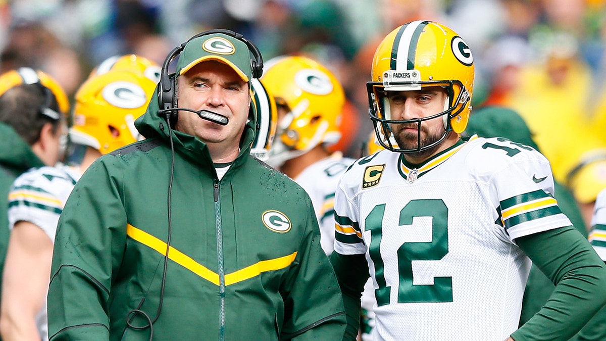 Mike MCCarthy and Aaron Rodgers connected  sideline