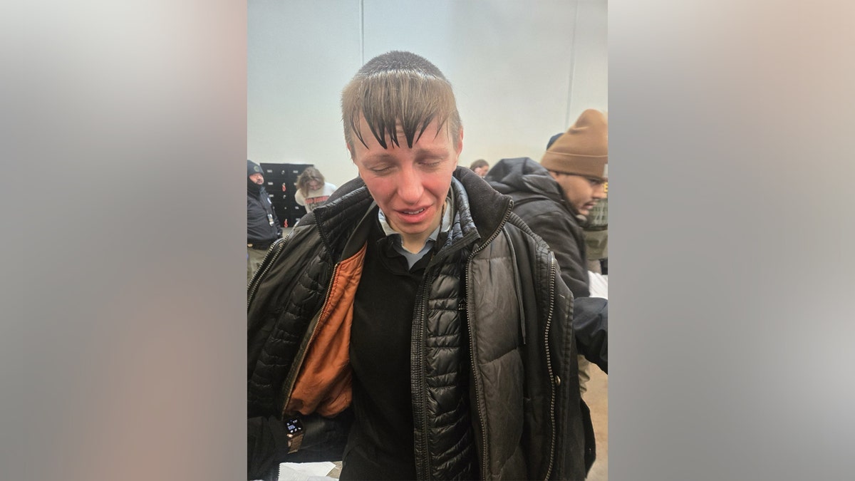 Man crying dressed in black jacket