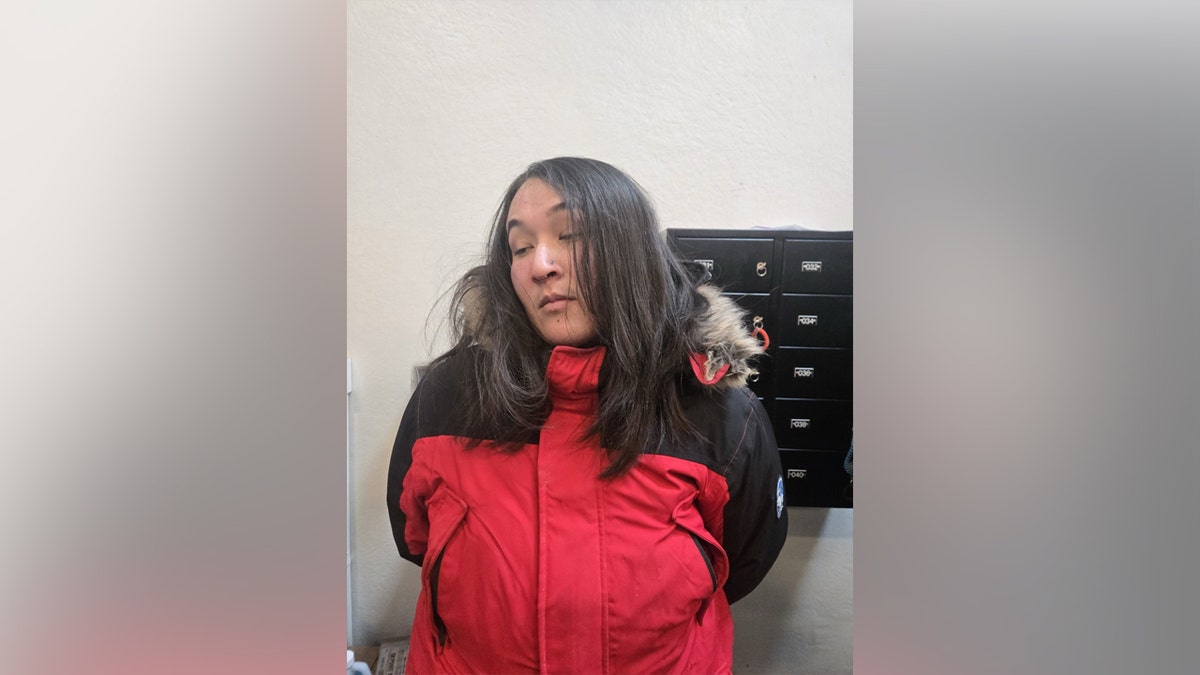 A woman wearing a red jacket looking off to the side