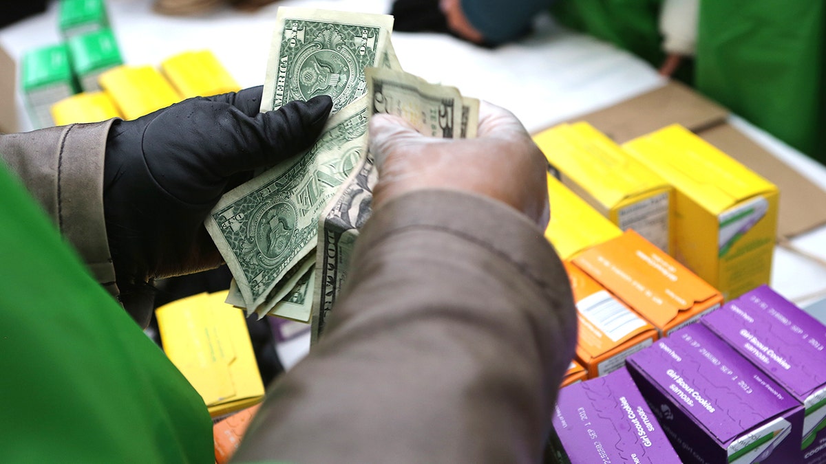Girl Scout cookie seller counting cash