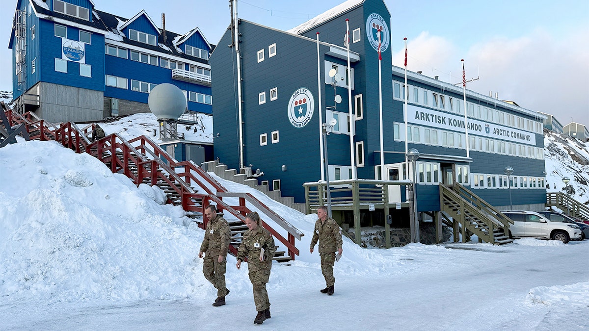 Danish soldiers walk past a military headquarters building in Greenland’s capital.