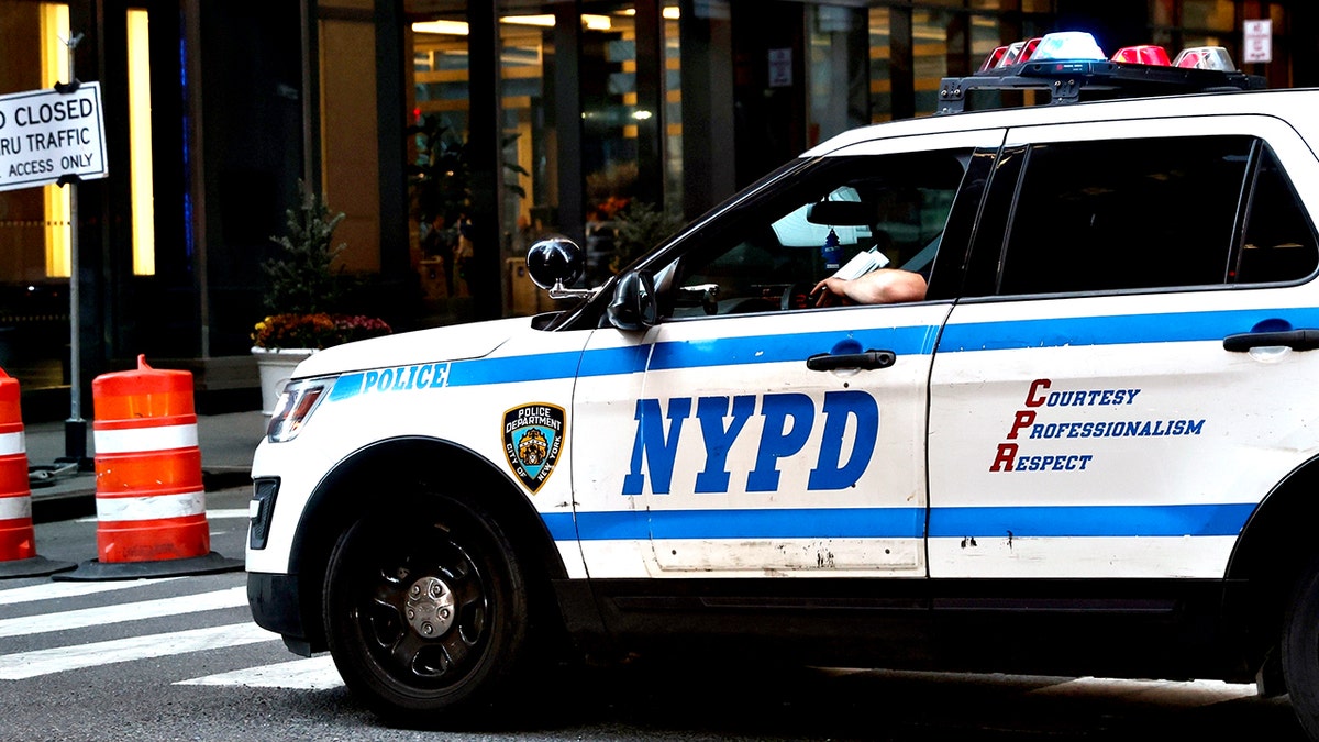 NYPD cruiser sits at an intersection 