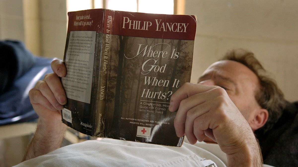 A man reads Philip Yancey's book