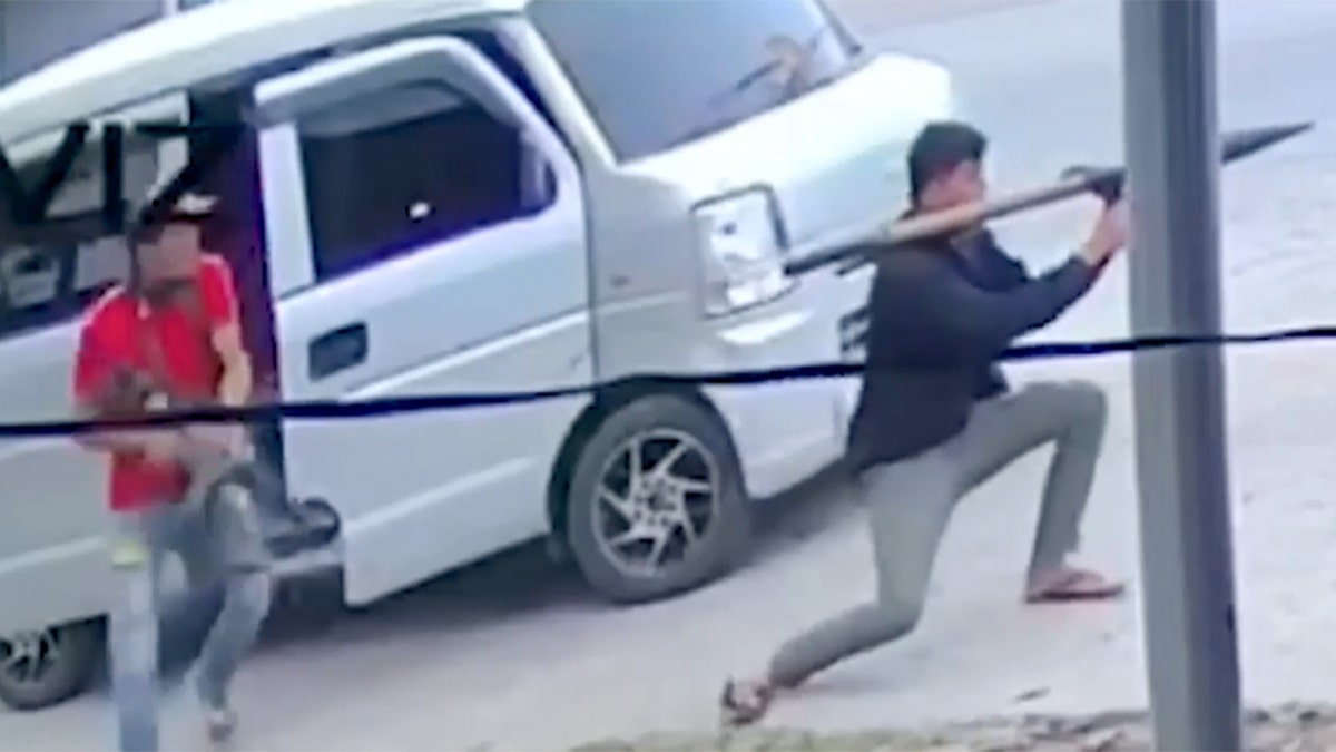 Men seen exiting a white van with weapons.
