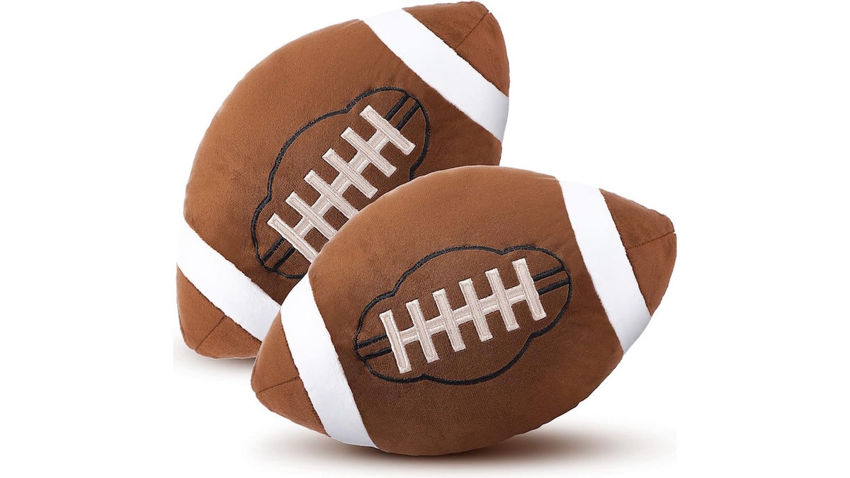 Relax and celebrate the game with football-shaped pillows.