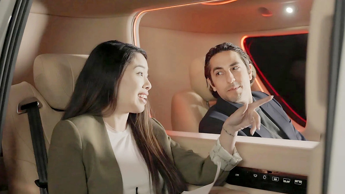 Two car passengers talk to each other.