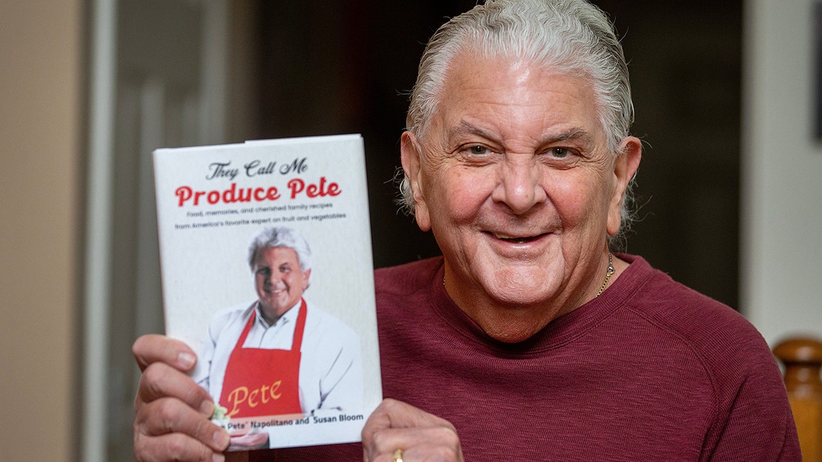 Peter Napolitano posing with his autobiography "They Call Me Produce Pete."
