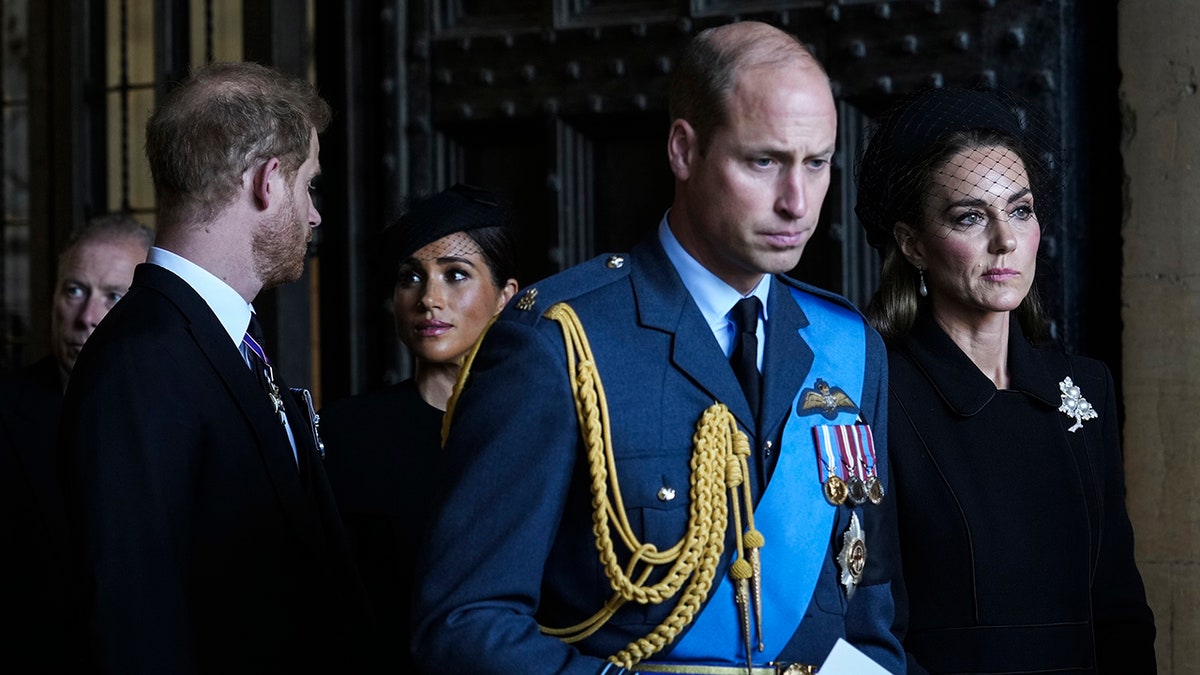 Prince William and Kate Middleton walking ahead of Prince Harry and Meghan Markle at Queen Elizabeth's funeral.