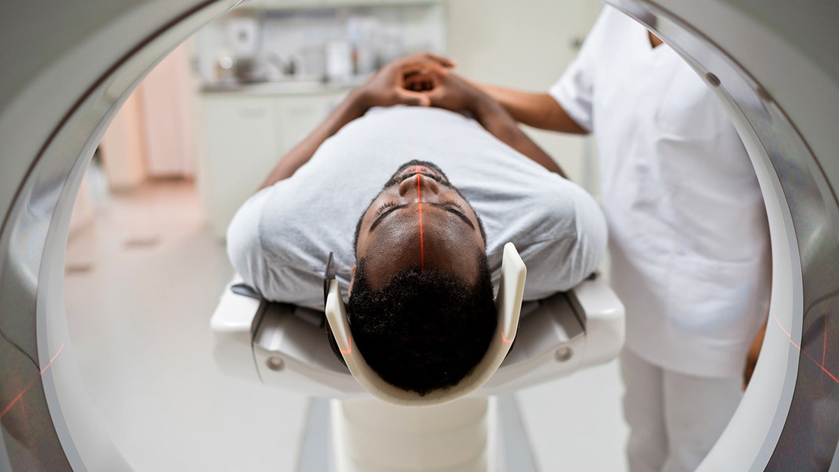 Male patient undergoing MRI scan in medical examination room