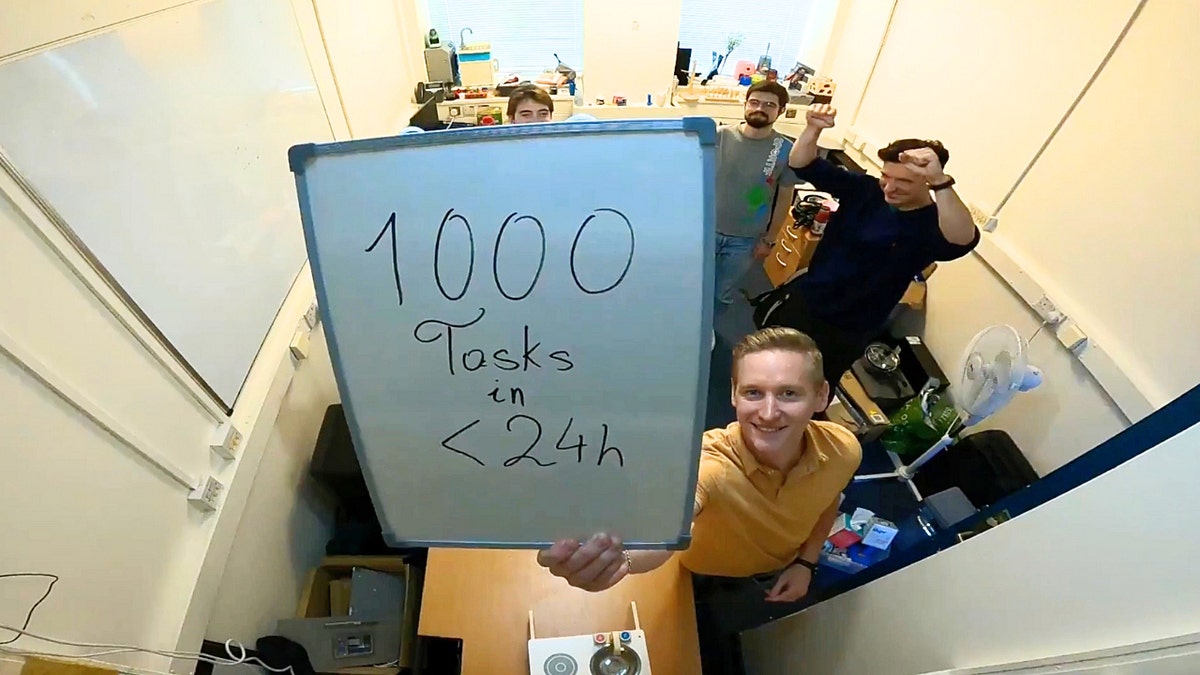 A man holding up a white board