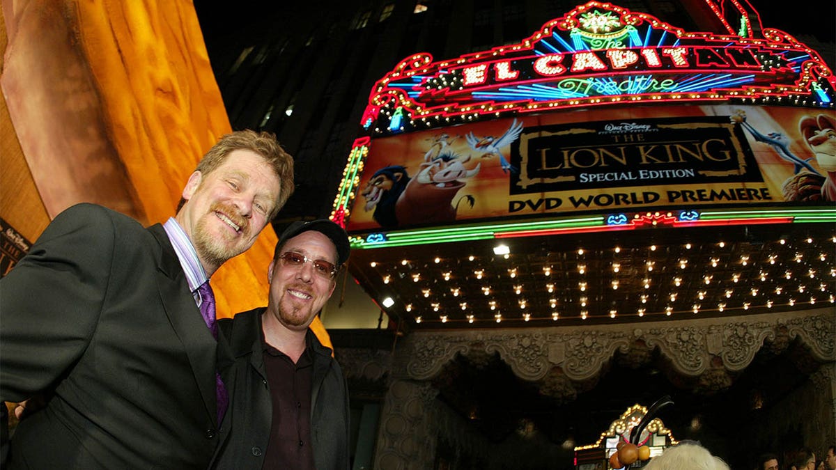 Roger Allers and Rob Minkoff pose in front of "The Lion King" marquee
