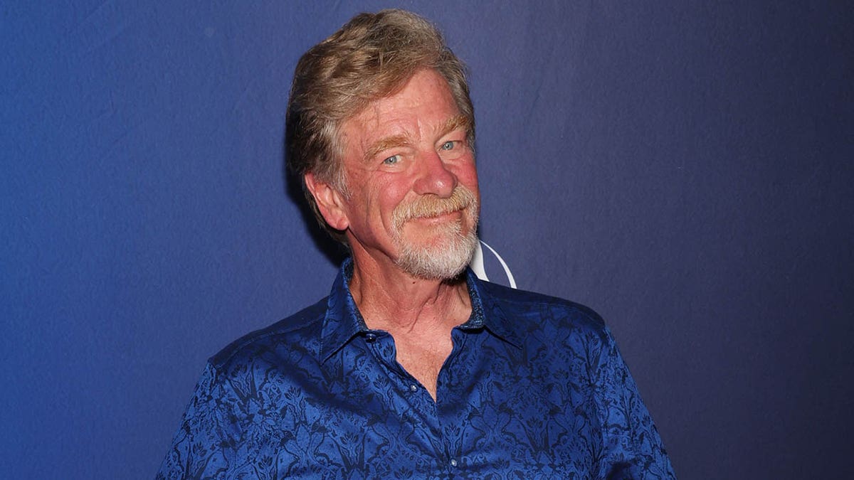 Roger Allers smiling against blue background