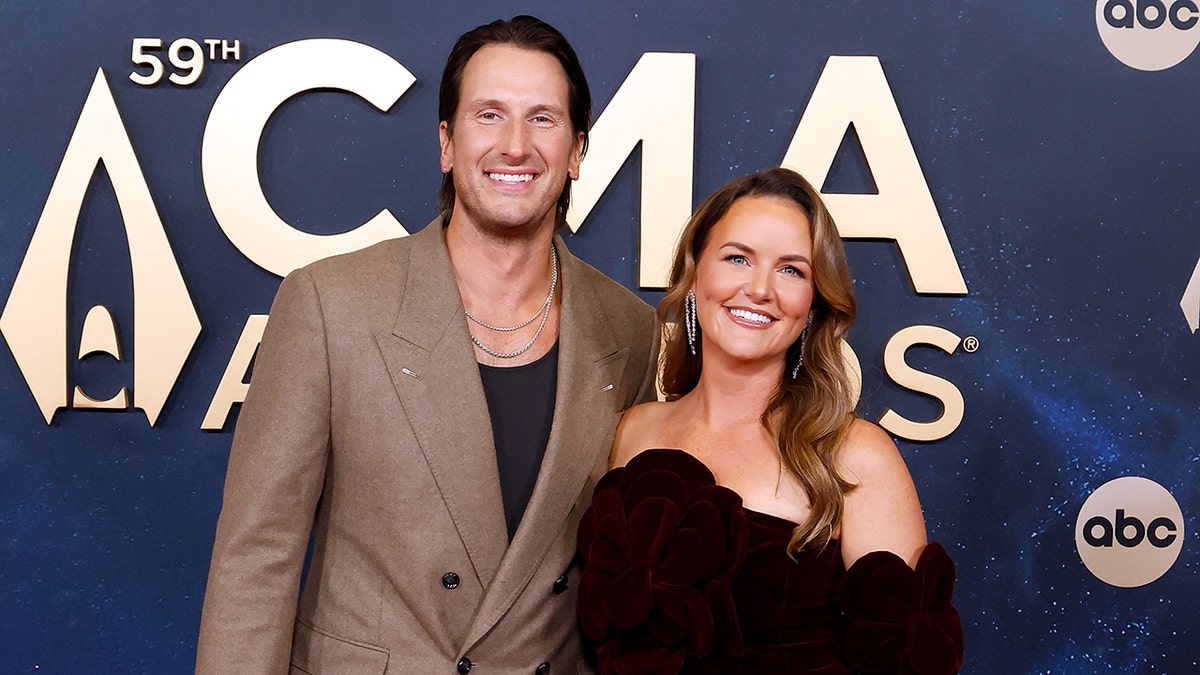 Country music singer Russell Dickerson poses with his wife, Kailey, at the CMAS