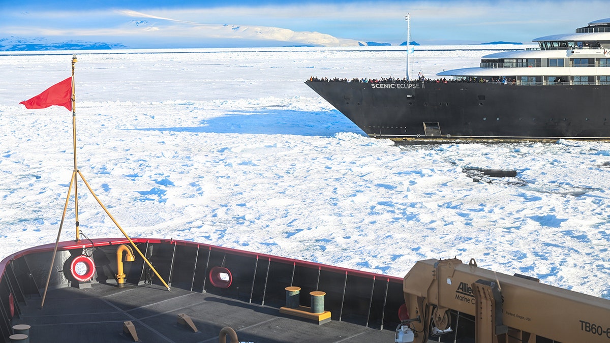 Scenic Eclipse II expedition cruise ship traveling through Antarctic sea ice under blue skies