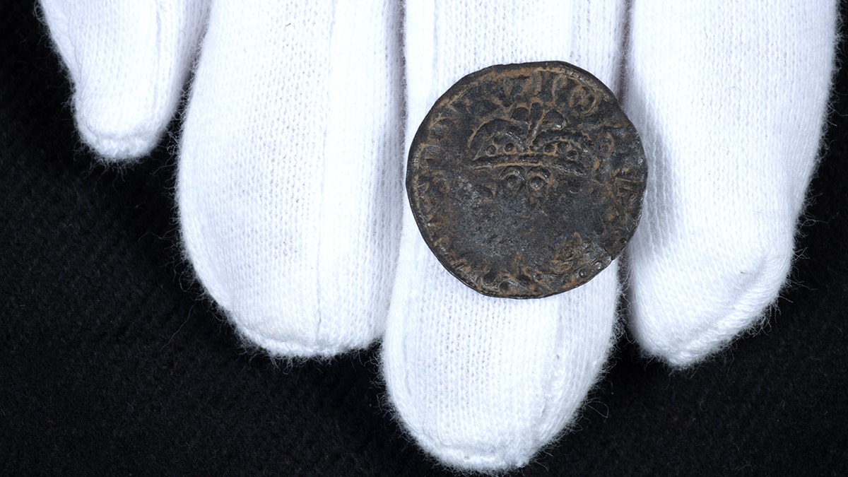 Curator holding scottish penny