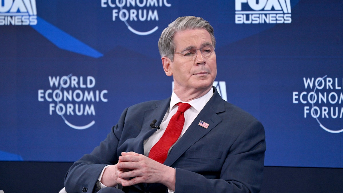 The U.S. Treasury secretary addresses an international audience from a conference stage.