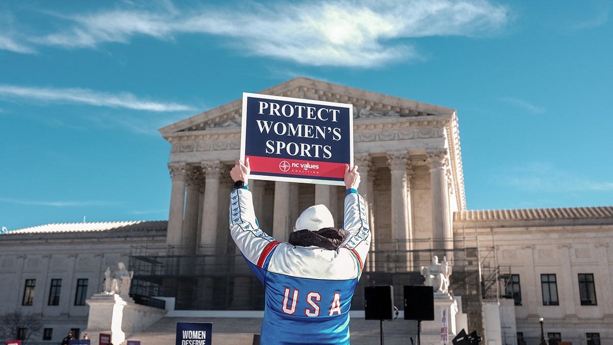 A demonstrator holds a sign outside the Supreme Court in Washington, D.C., on Tuesday, Jan. 13, 2026.