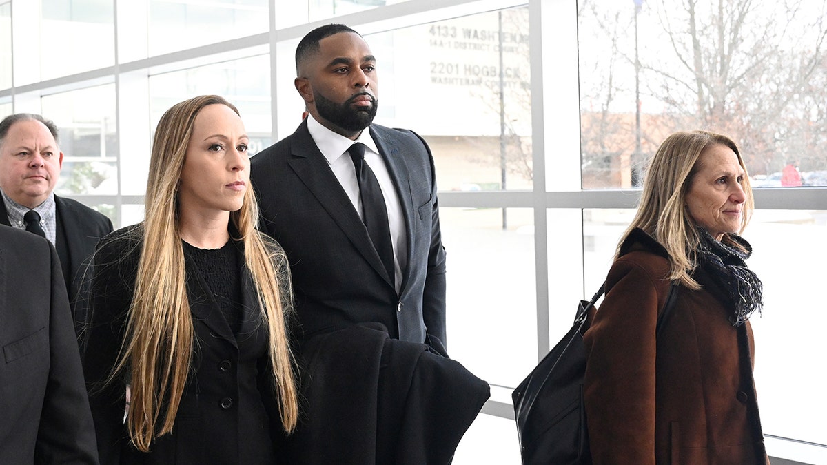Sherrone Moore, wife, and lawyer  locomotion  into court